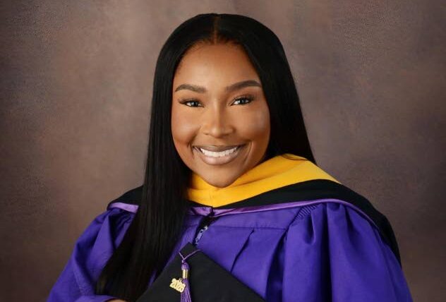 Netania Mundell smiling in graduation robes